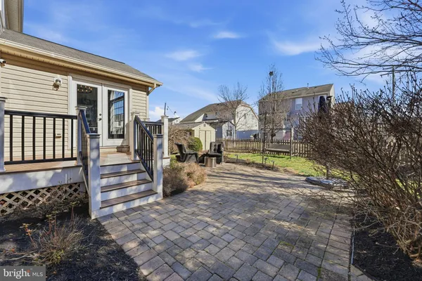a front view of a house with a garden and plants