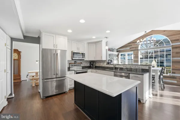 a stove top oven sitting inside of a kitchen