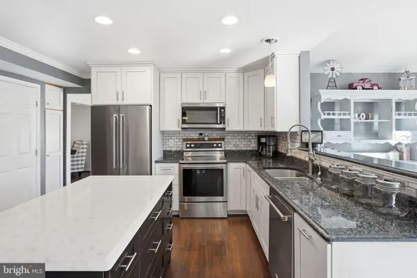 a kitchen with a refrigerator stove and wooden cabinets