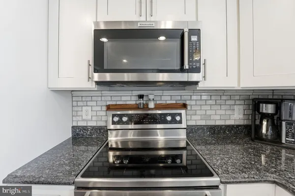 a kitchen with lots of counter top space and sink