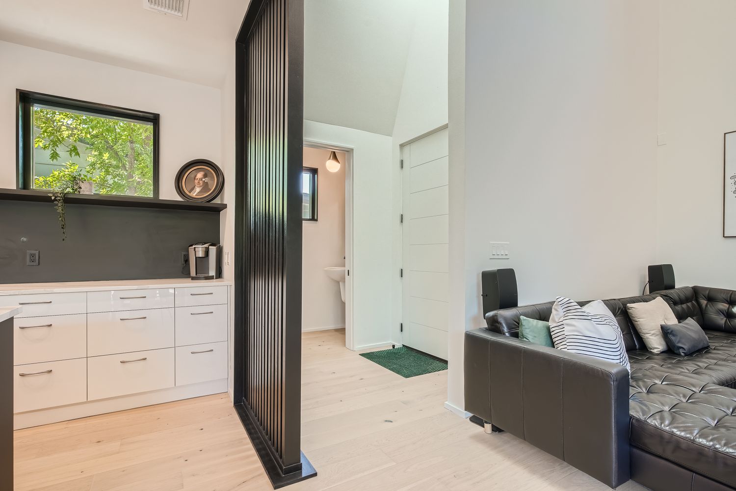 7525 Delafield Lane, Unit A Austin, TX 78752 - Photo 4 of 33 Bedroom with light wood-style floors, vaulted ceiling, and connected bathroom