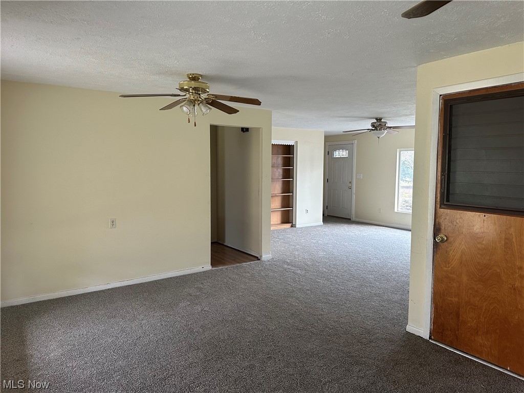 4410 Lane Road Painesville, OH 44077 - Photo 5 of 30 Carpeted empty room with ceiling fan and a textured ceiling