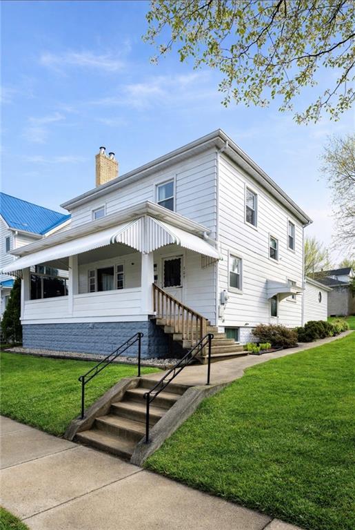 a front view of a house with a garden and yard