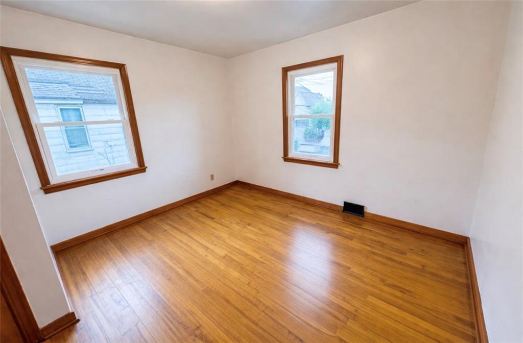 309 Emerson Street Vandergrift, PA 15690 - Photo 22 of 36 a view of an empty room with wooden floor and a window