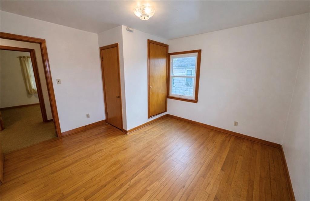 309 Emerson Street Vandergrift, PA 15690 - Photo 23 of 36 a view of an empty room with wooden floor and a window
