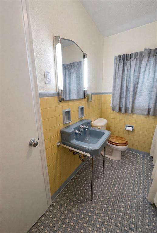 309 Emerson Street Vandergrift, PA 15690 - Photo 24 of 36 a bathroom with a sink a toilet a mirror and vanity
