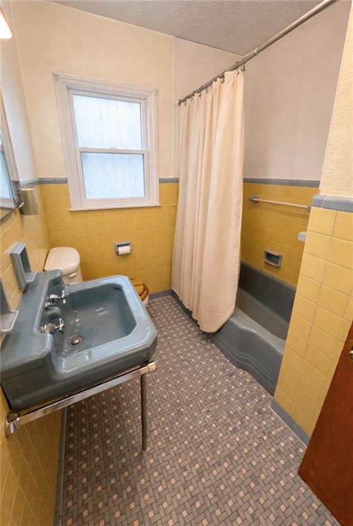 309 Emerson Street Vandergrift, PA 15690 - Photo 28 of 36 a bathroom with a sink a mirror and a shower