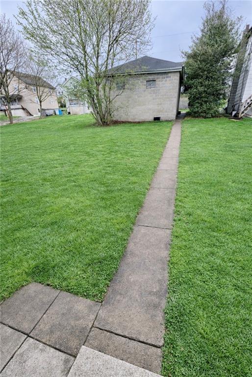 309 Emerson Street Vandergrift, PA 15690 - Photo 34 of 36 a view of a yard with tree s