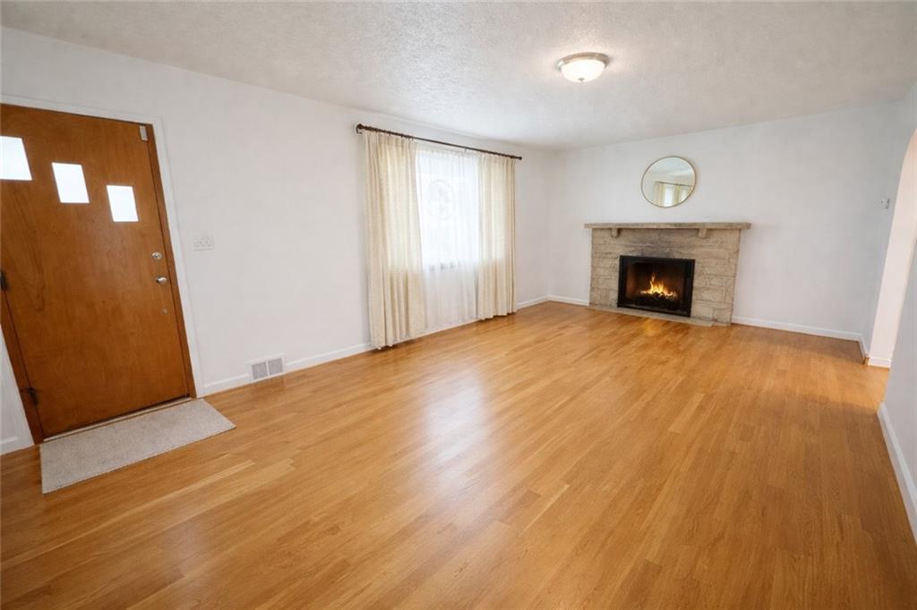 309 Emerson Street Vandergrift, PA 15690 - Photo 4 of 36 a view of an empty room with wooden floor and a window