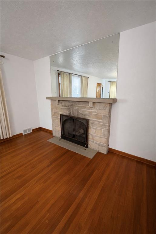 309 Emerson Street Vandergrift, PA 15690 - Photo 6 of 36 a view of empty room with wooden floor and fireplace