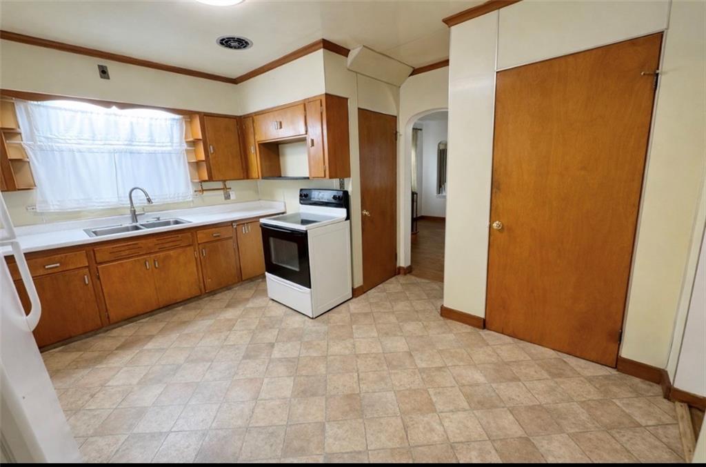 309 Emerson Street Vandergrift, PA 15690 - Photo 9 of 36 a large kitchen with a sink and cabinets