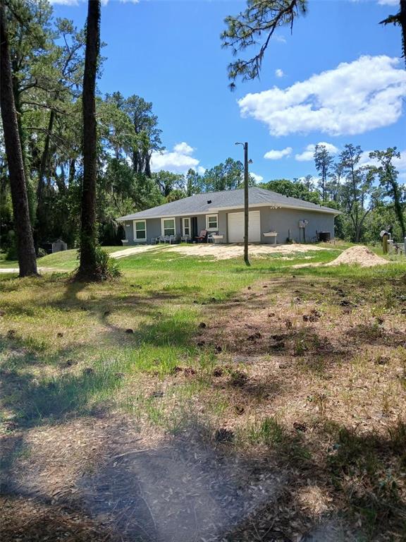 6800 Northeast 175th Street Road Citra, FL 32113 - Photo 1 of 27 a view of a backyard with large trees