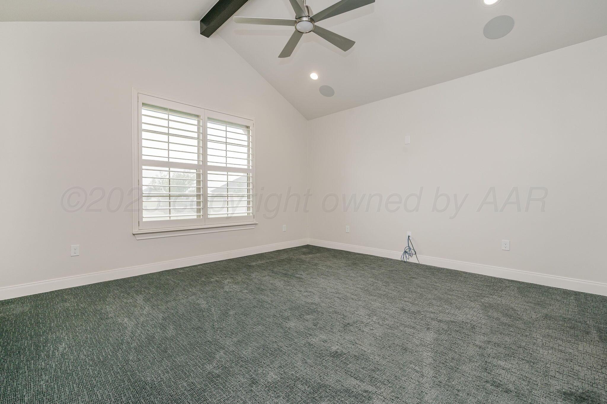 9734 Cicada Trail Amarillo, TX 79119 - Photo 13 of 34 an empty room with a ceiling fan and windows