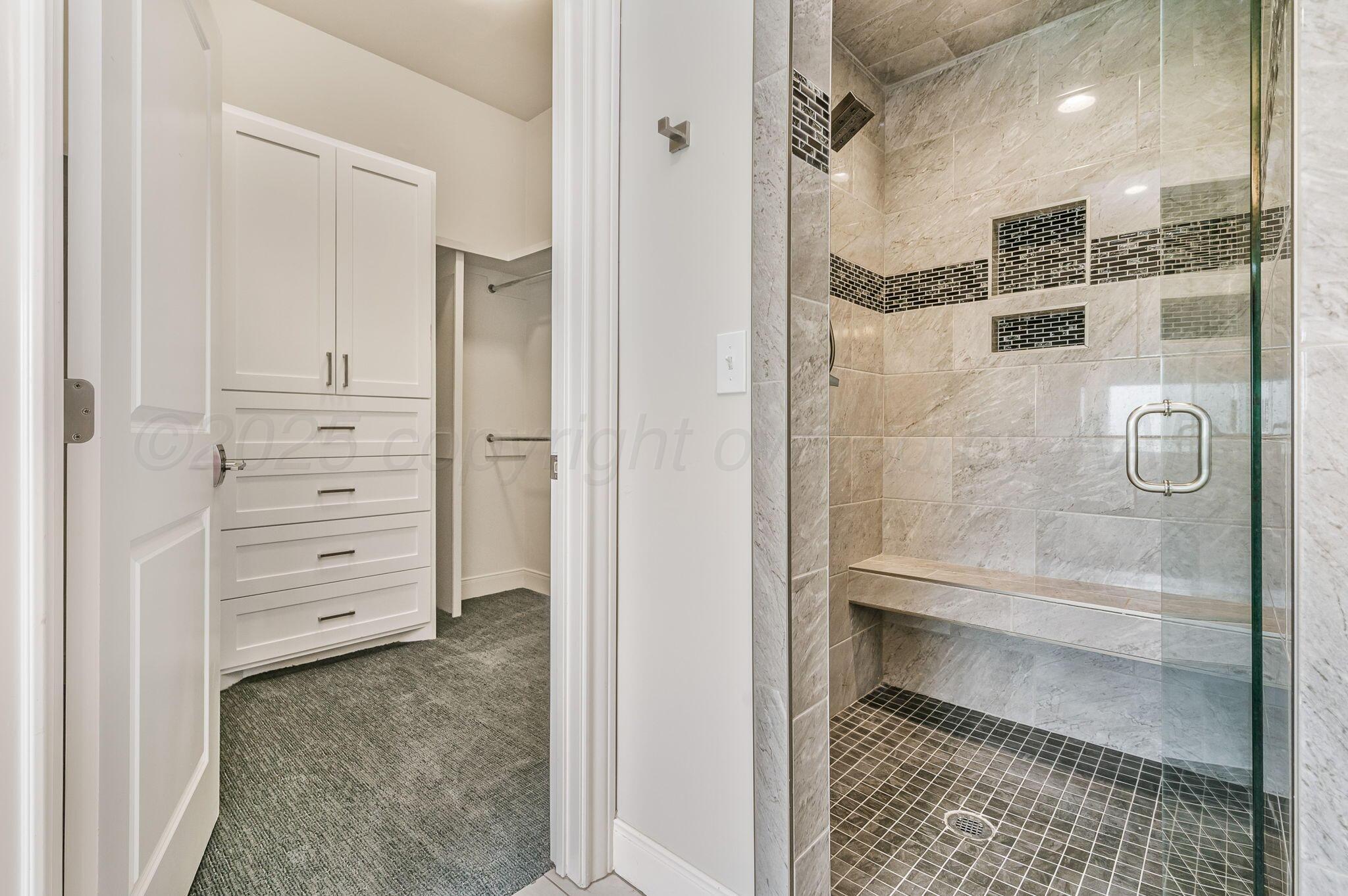 9734 Cicada Trail Amarillo, TX 79119 - Photo 16 of 34 a bathroom with a glass shower door