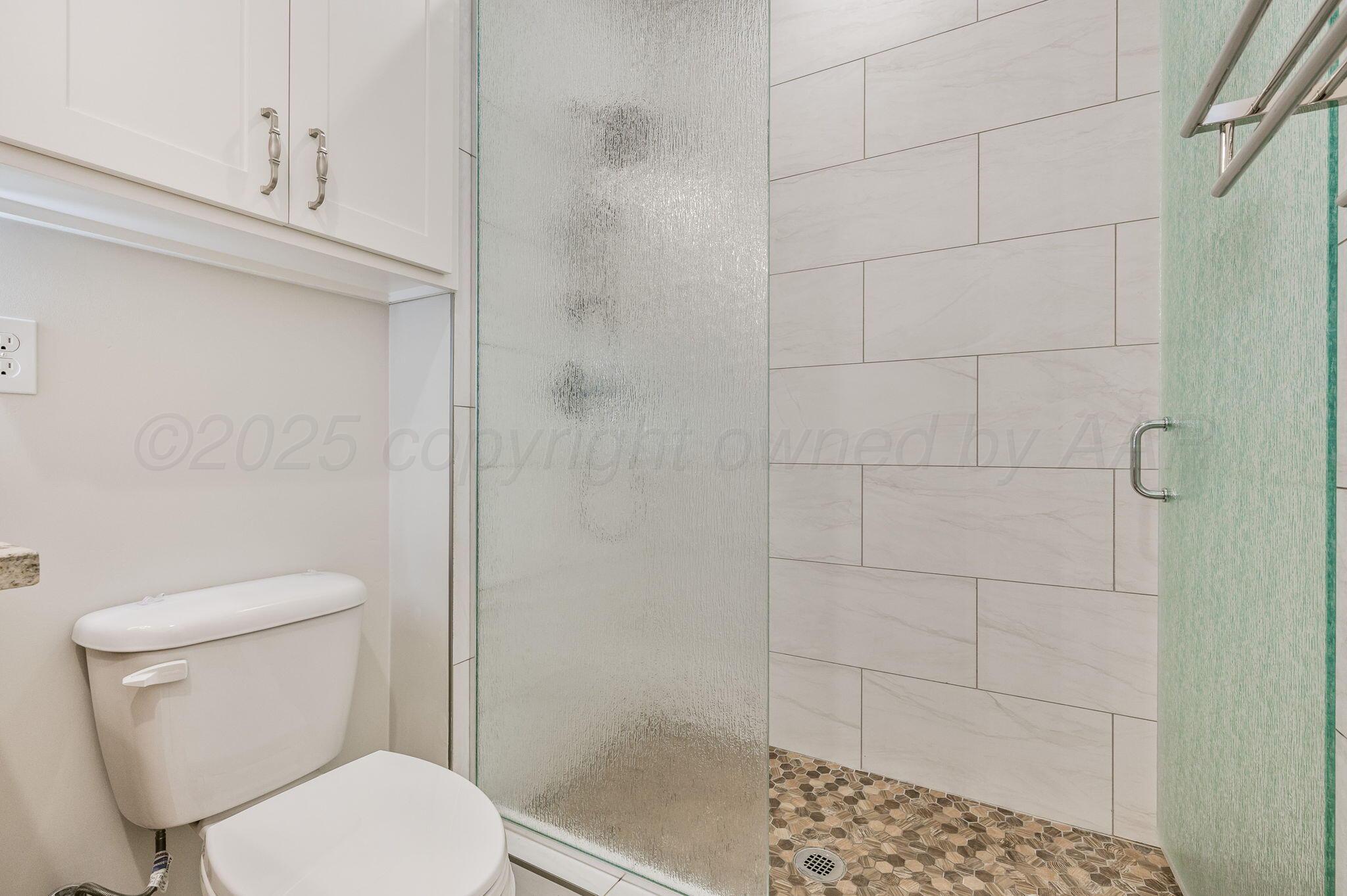 9734 Cicada Trail Amarillo, TX 79119 - Photo 21 of 34 a white toilet sitting next to a bathroom
