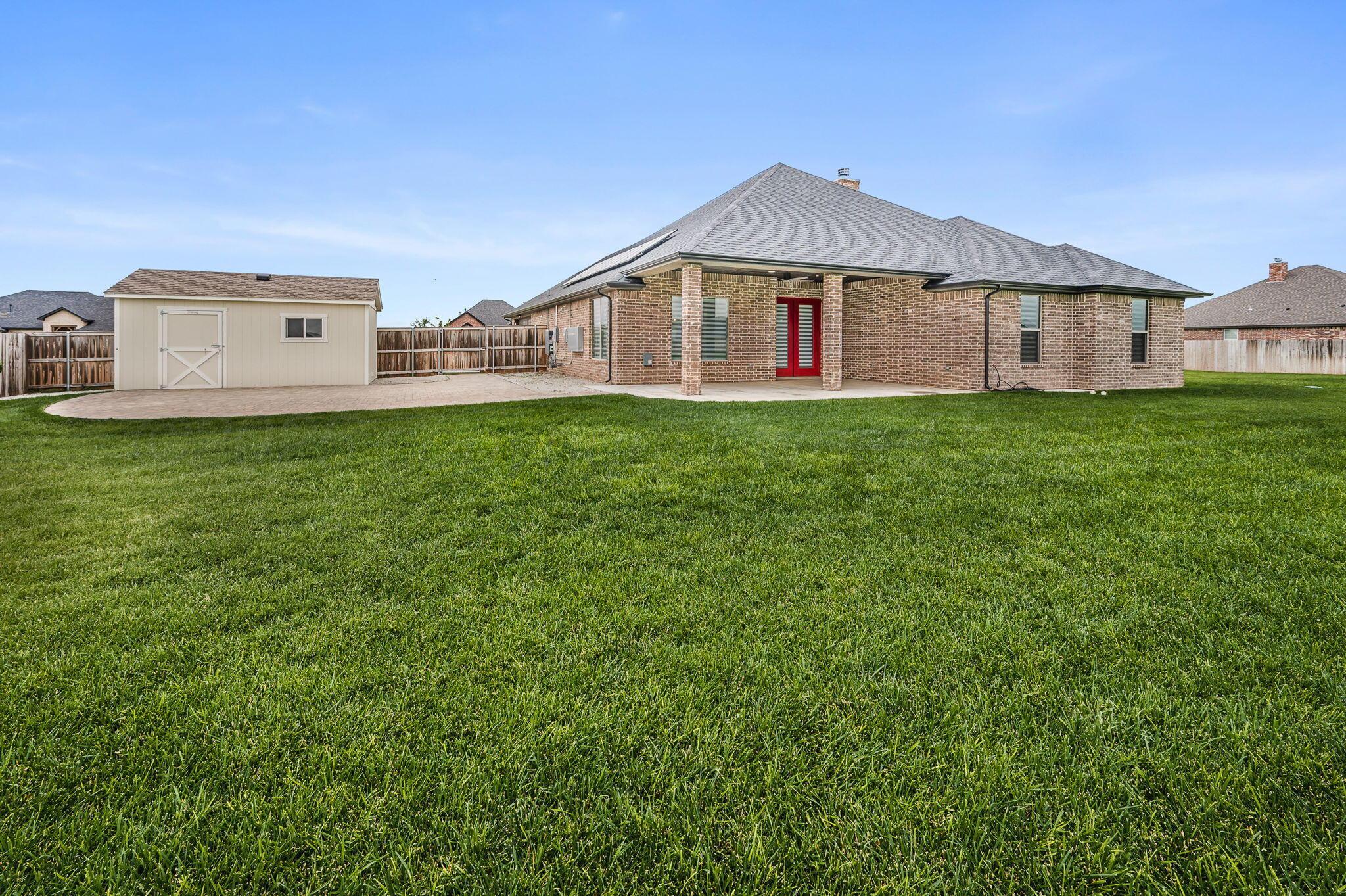9734 Cicada Trail Amarillo, TX 79119 - Photo 26 of 34 a front view of a house with a garden