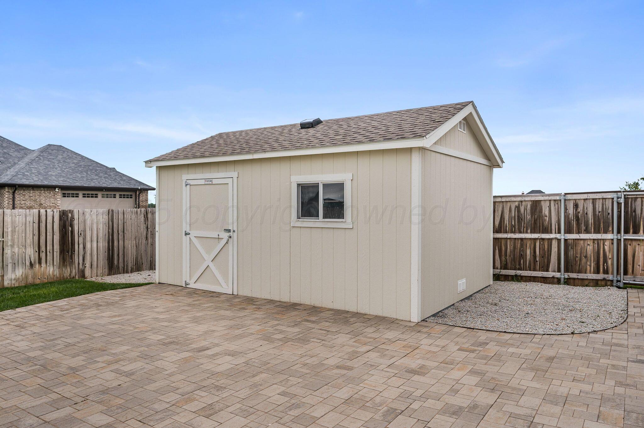 9734 Cicada Trail Amarillo, TX 79119 - Photo 28 of 34 a view of backyard with small cabin and wooden fence
