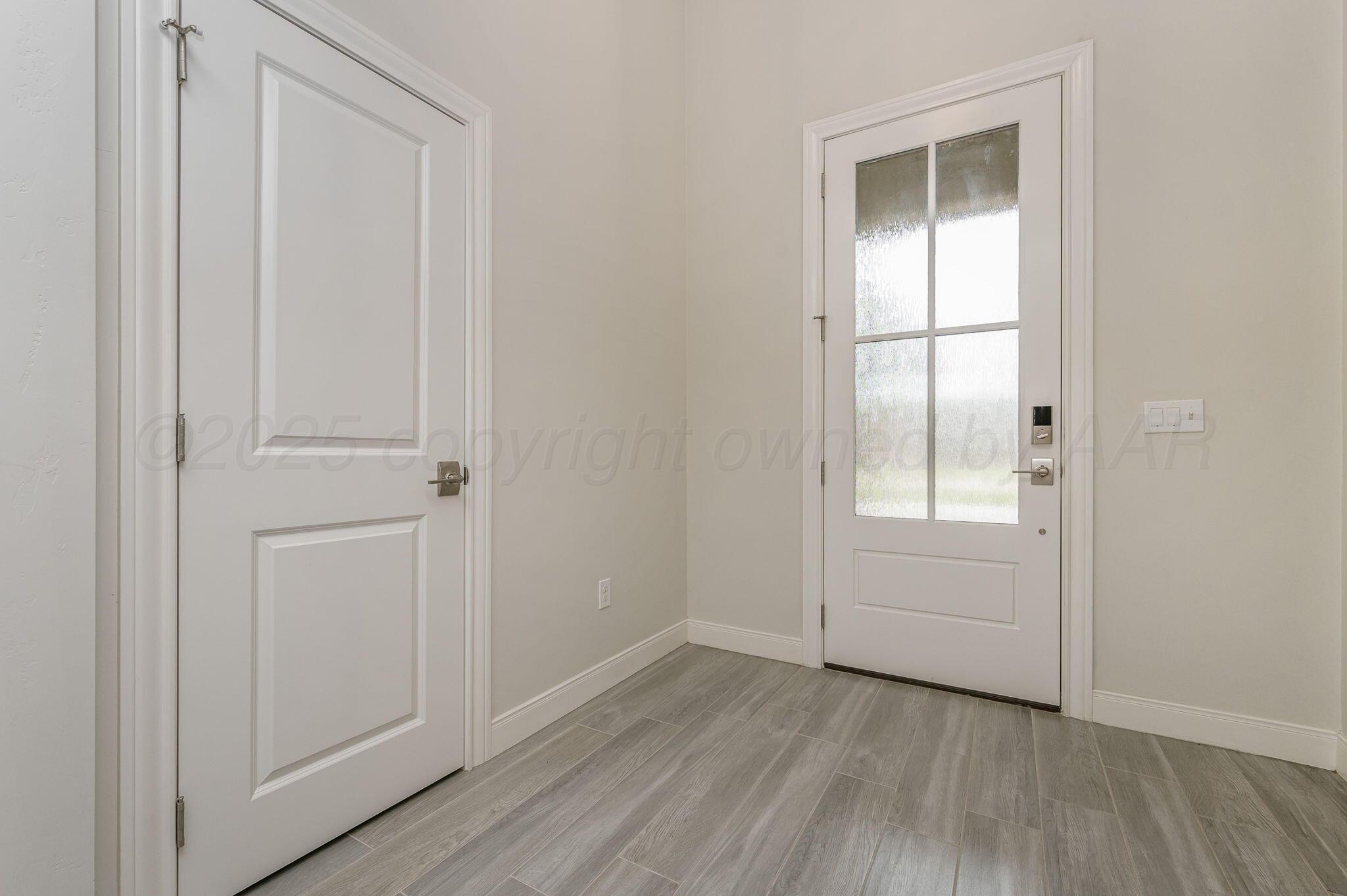 9734 Cicada Trail Amarillo, TX 79119 - Photo 5 of 34 an empty room with wooden floor and windows