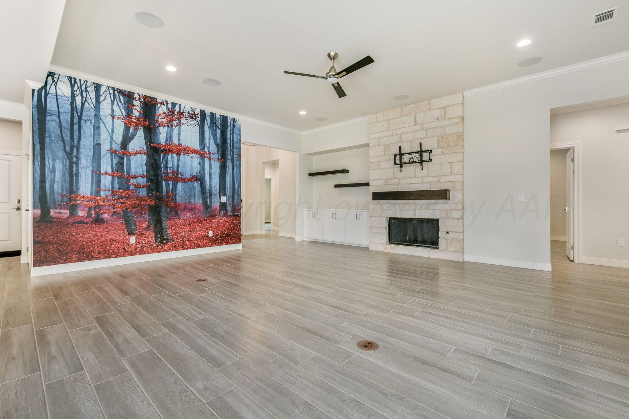9734 Cicada Trail Amarillo, TX 79119 - Photo 7 of 34 a view of a livingroom with furniture hardwood floor and a ceiling fan