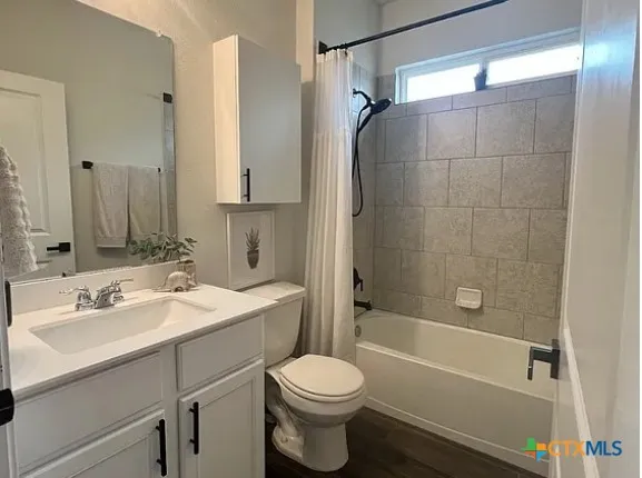 a bathroom with a sink toilet vanity and shower