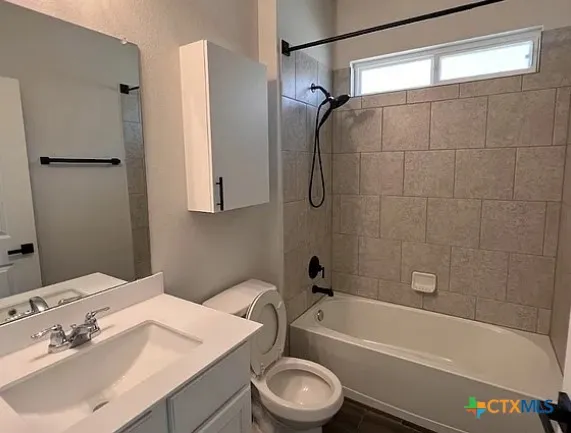 a bathroom with a sink a toilet and a bathtub