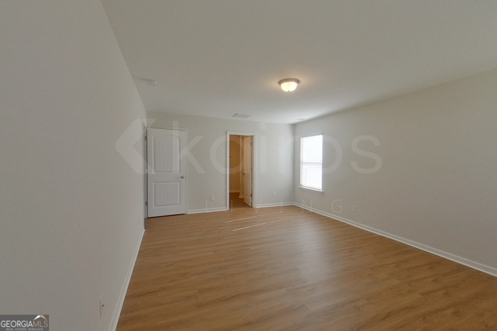 106 Ebenezer Blf Way Springfield, GA 31329 - Photo 12 of 19 a view of an empty room with wooden floor and window