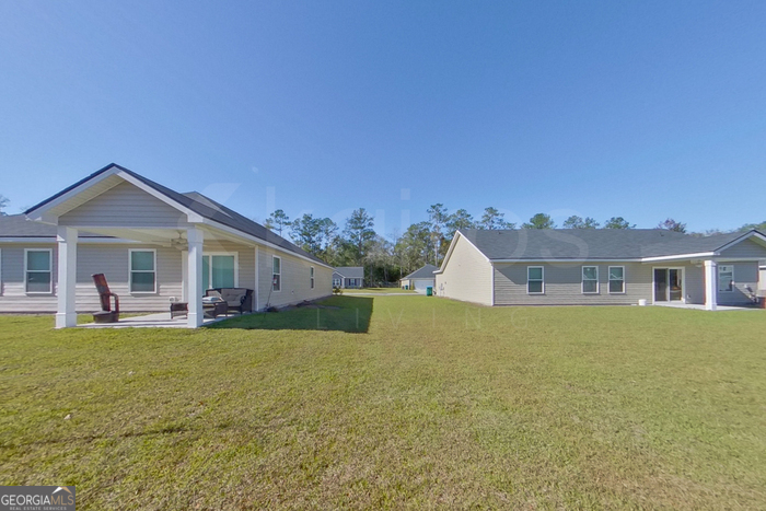 106 Ebenezer Blf Way Springfield, GA 31329 - Photo 16 of 19 a front view of house with yard barbeque and outdoor seating