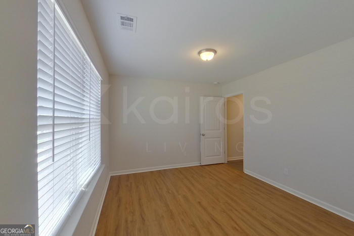 106 Ebenezer Blf Way Springfield, GA 31329 - Photo 5 of 19 a view of a room with wooden floor and brick walls