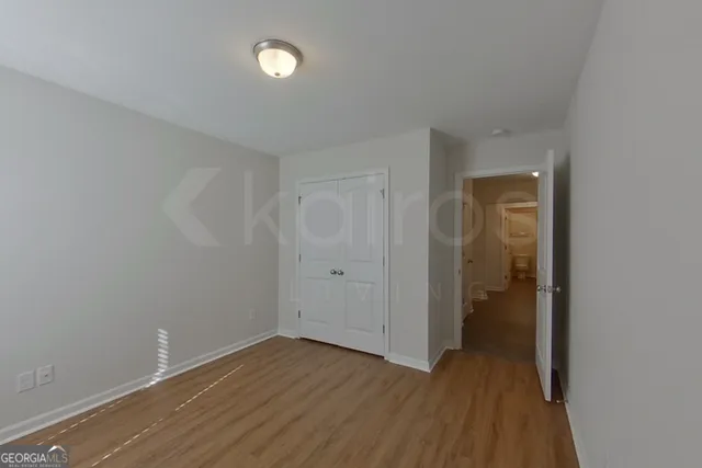 a view of a room with wooden floor