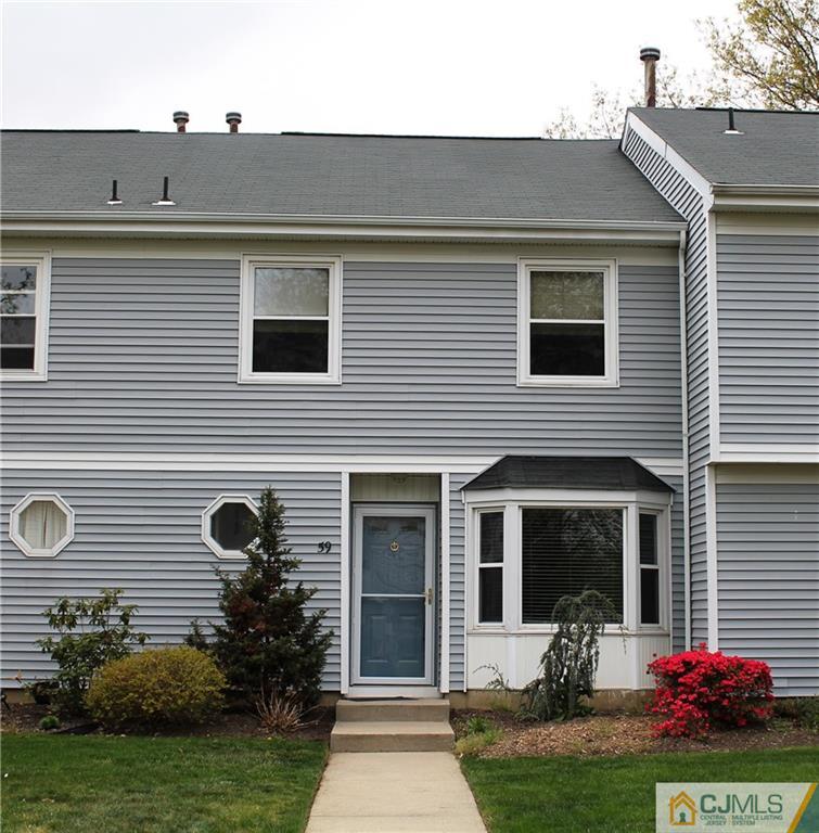 59 La Rue Lane, Unit 59 East Brunswick, NJ 08816 - Photo 1 of 17 a front view of a house with garden