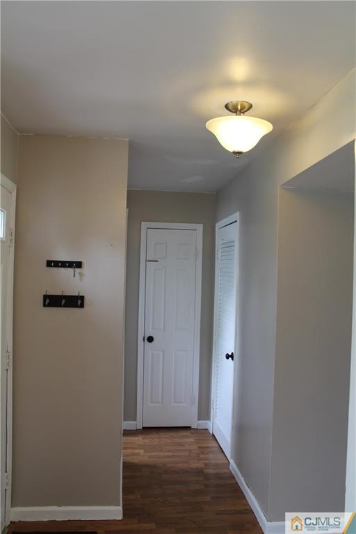 59 La Rue Lane, Unit 59 East Brunswick, NJ 08816 - Photo 4 of 17 a view of a hallway with wooden floor