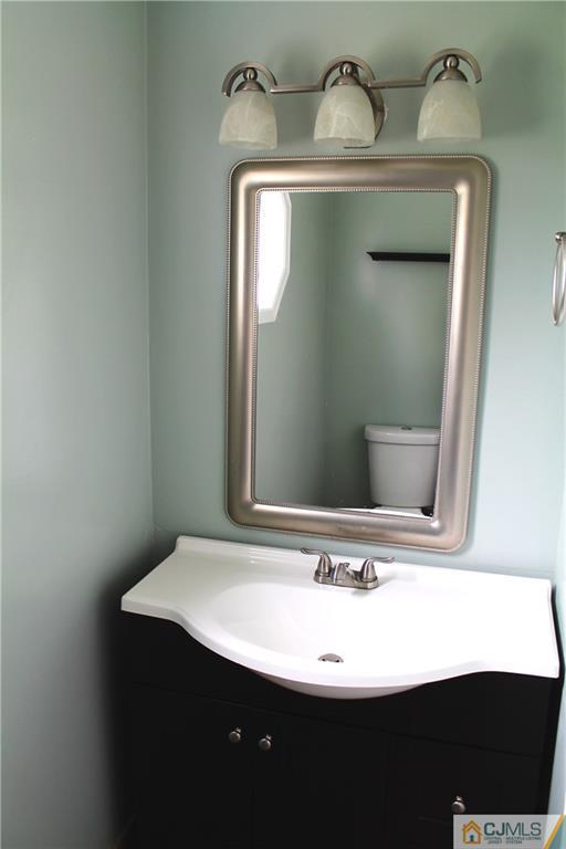 59 La Rue Lane, Unit 59 East Brunswick, NJ 08816 - Photo 6 of 17 a bathroom with a sink and a mirror