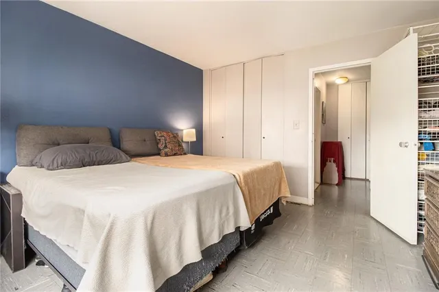 a bedroom with a bed and a walk in closet