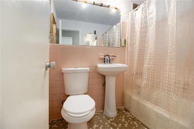 a bathroom with a sink toilet and bathtub