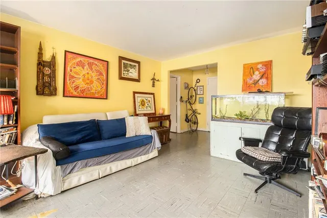 a living room with furniture and a floor to ceiling window