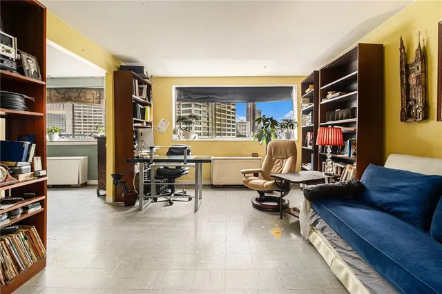 a living room with furniture gym equipment and a large window