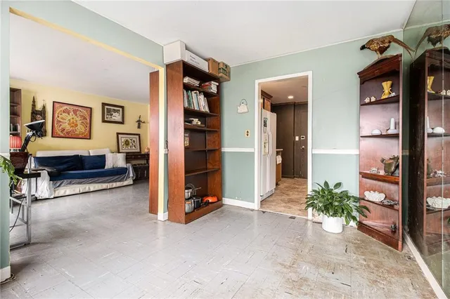 a living room with furniture gym equipment and a table