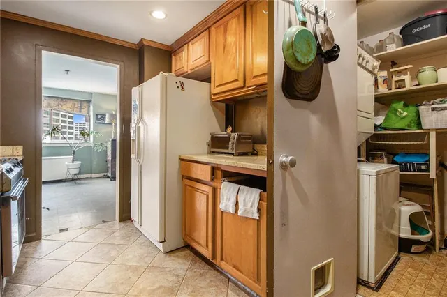a kitchen with stainless steel appliances granite countertop a refrigerator and a stove