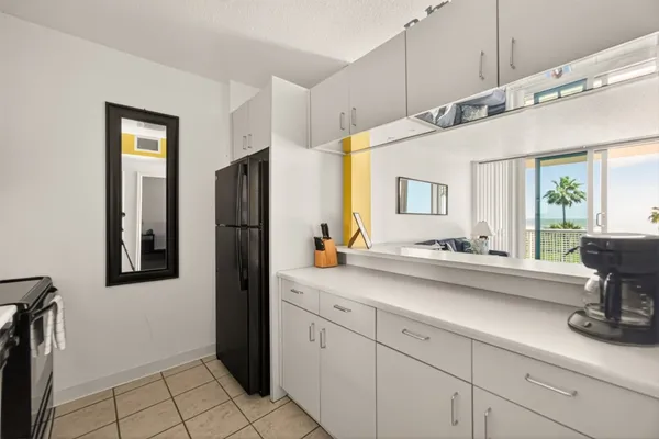 a kitchen with a sink and refrigerator