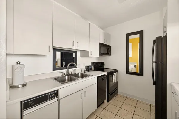 a kitchen with stainless steel appliances a sink stove and cabinets