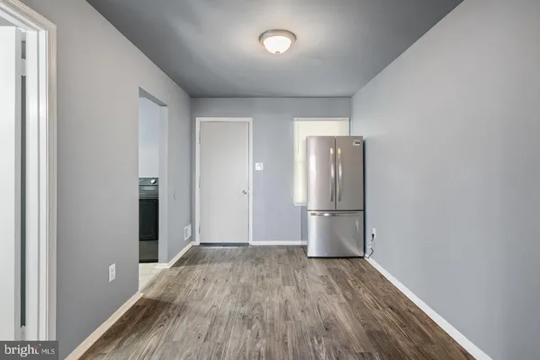a view of a kitchen with a sink and refrigerator
