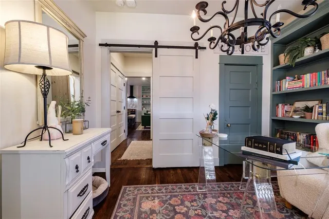 a living room with furniture and a book shelf