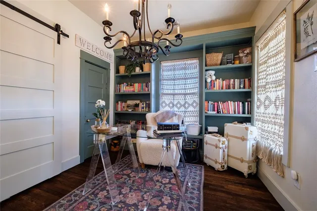 a living room with furniture and a chandelier