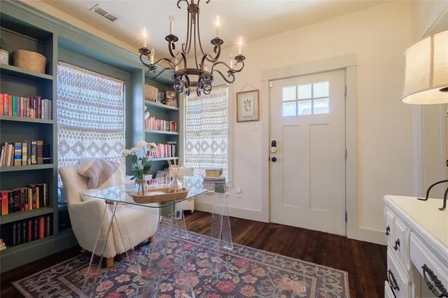 a bedroom with furniture and a large window