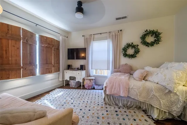 a bedroom with a large bed couch and a window