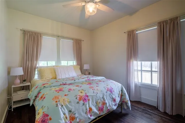 a bathroom with a granite countertop sink a toilet a mirror and shower