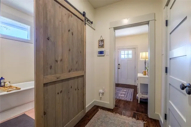 a bathroom with a bathtub and a mirror