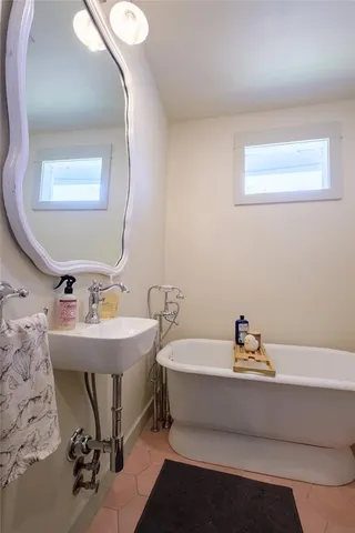 a living room with a bed and a window