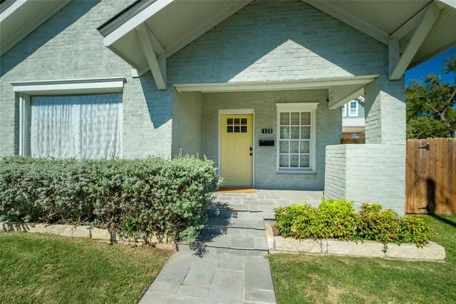 a view of a big house with a big yard and large trees
