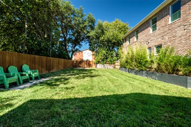 a view of a porch with furniture and a yard